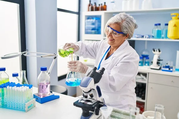 Middle Age Woman Wearing Scientist Uniform Pouring Liquid Test Tube — 图库照片