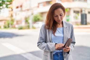 Young woman executive holding wallet at street