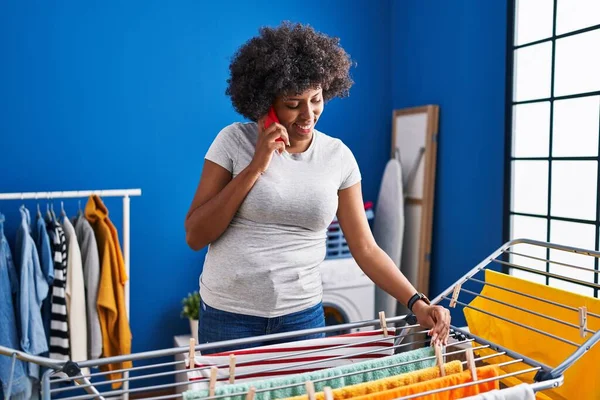 African American Woman Talking Smartphone Hanging Clothes Clothesline Laundry Room — Stock fotografie