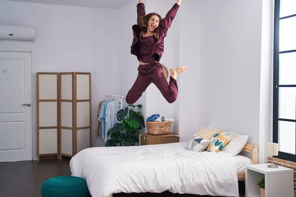 Young Woman Smiling Confident Jumping Bed Bedroom — ストック写真