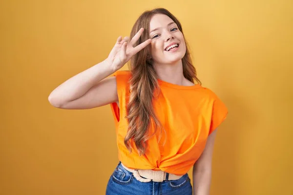 Caucasian Woman Standing Yellow Background Doing Peace Symbol Fingers Face — Zdjęcie stockowe