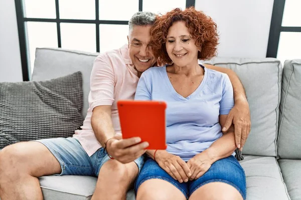 Middle Age Man Woman Couple Using Touchpad Hugging Each Other — Stock Photo, Image