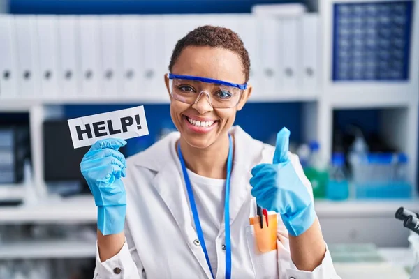 科学研究所で働いている美しいアフリカ系アメリカ人女性が笑顔と肯定的な助けを求めています 親指アップ優れたと承認のサインを行います — ストック写真