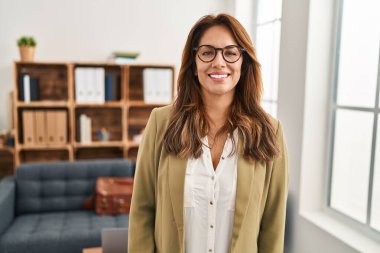 Hispanic woman working at consultation office with a happy and cool smile on face. lucky person. 