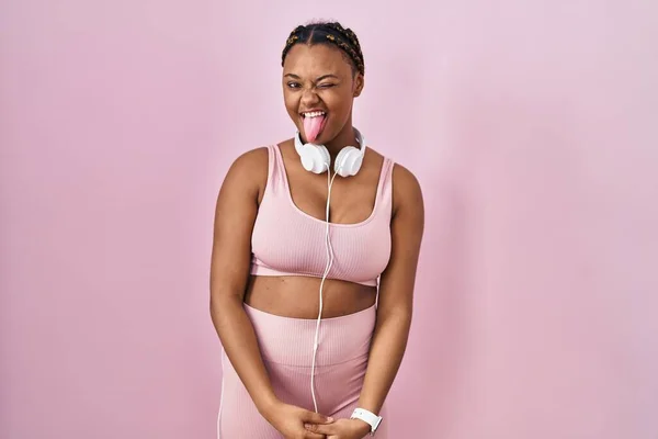 African American Woman Braids Wearing Sportswear Headphones Sticking Tongue Out — Stock Photo, Image