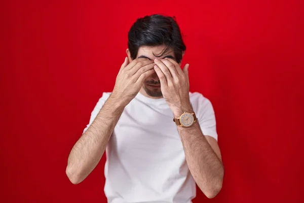 Young Hispanic Man Standing Red Background Rubbing Eyes Fatigue Headache — Stockfoto