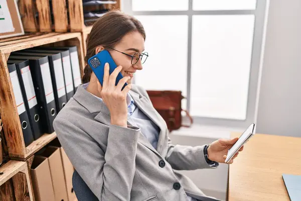 Young Caucasian Woman Business Worker Talking Smartphone Reading Notebook Office — Stock fotografie