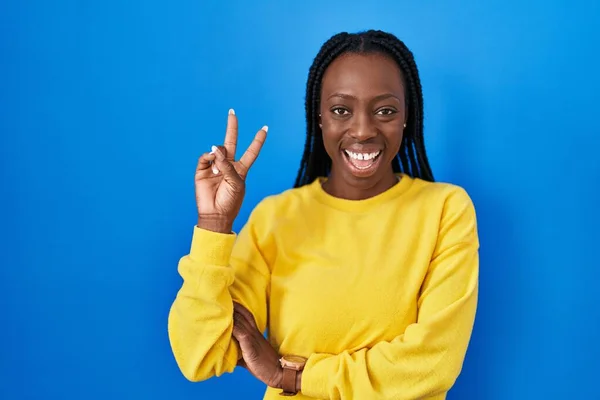 Beautiful Black Woman Standing Blue Background Smiling Happy Face Winking — Stok fotoğraf