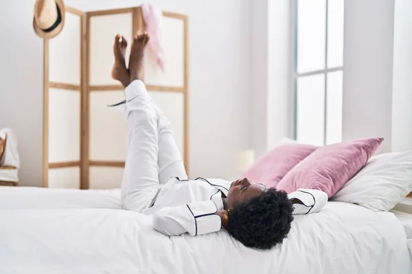 Young African American Woman Lying Bed Legs Raised Bedroom — Fotografia de Stock