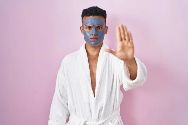 Young Hispanic Man Wearing Beauty Face Mask Bath Robe Doing — Stock fotografie