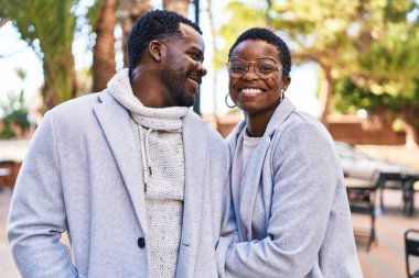 Man and woman couple smiling confident standing together at park