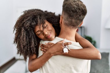 Man and woman couple smiling confident hugging each other at home