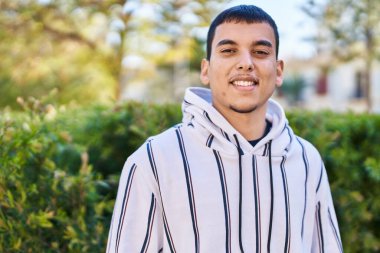 Parkta kendinden emin bir şekilde duran genç adam.