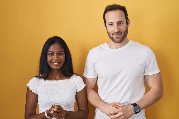 Interracial Couple Standing Yellow Background Hands Together Crossed Fingers Smiling — 图库照片