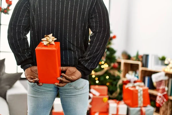 Young African American Man Holding Gift His Back Standing Christmas — стокове фото