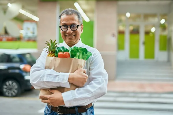 Middle Age Southeast Asian Man Smiling Holding Bag Fresh Groceries —  Fotos de Stock