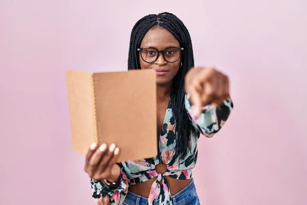 African Woman Braids Reading Book Pointing Finger Camera You Confident — Foto de Stock