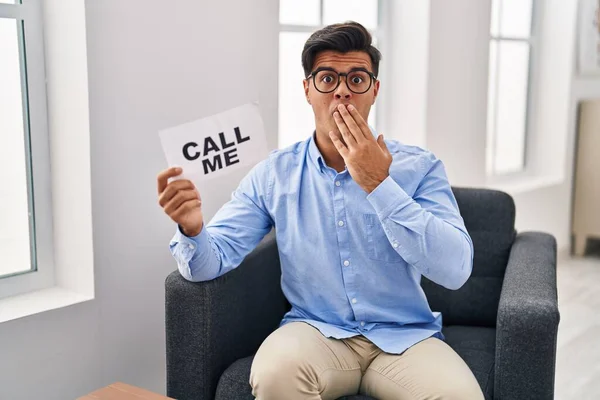 Hispanic Man Working Therapy Office Holding Call Banner Covering Mouth — Stock Photo, Image