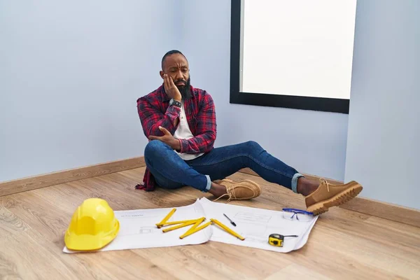 African American Man Sitting Floor New Home Looking Blueprints Thinking — Stock Photo, Image