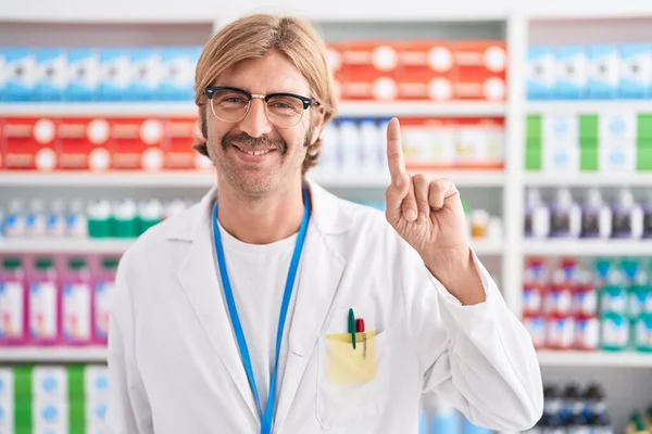 Caucasian Man Mustache Working Pharmacy Drugstore Showing Pointing Finger Number — Stock Photo, Image