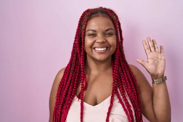 African american woman with braided hair standing over pink background showing and pointing up with fingers number five while smiling confident and happy.