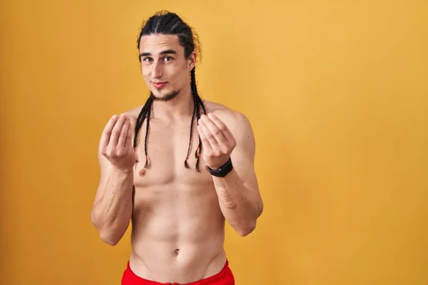 Hispanic Man Long Hair Standing Shirtless Yellow Background Doing Money — Stock fotografie