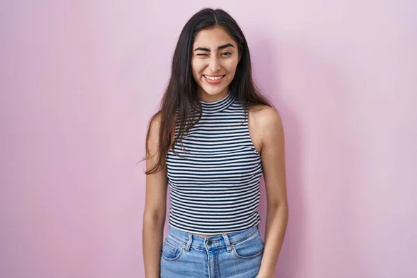 Young Teenager Girl Wearing Casual Striped Shirt Winking Looking Camera — Stockfoto