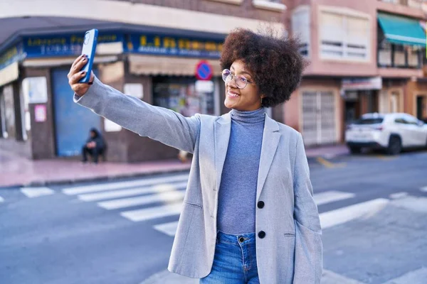 African american woman executive making selfie by smartphone at street