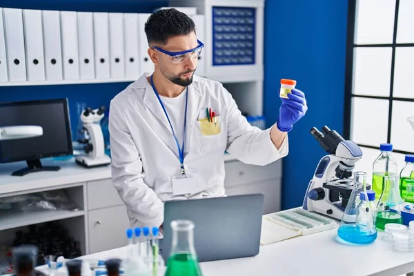 Young Arab Man Scientist Using Laptop Holding Urine Test Tube — Stock Photo, Image