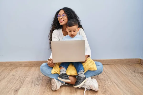Young Hispanic Mother Kid Using Computer Laptop Sitting Floor Looking - Stock-foto