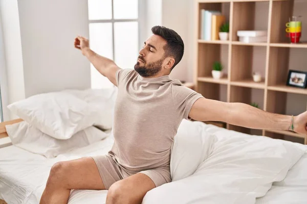 Young Hispanic Man Waking Stretching Arms Bedroom — Foto Stock
