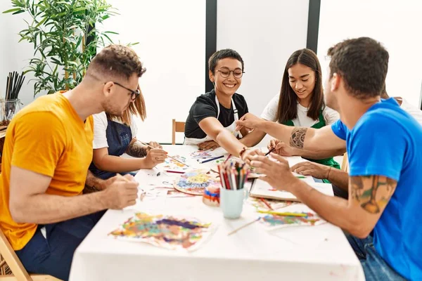 Group of people drawing at art studio.