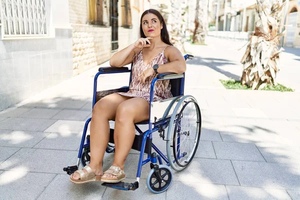 Young Brunette Woman Sitting Wheelchair Outdoors Serious Face Thinking Question — Stock Photo, Image