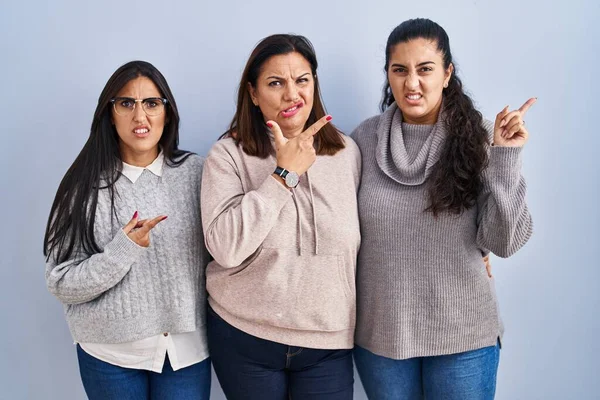 Mother Two Daughters Standing Blue Background Pointing Aside Worried Nervous — Stock Photo, Image