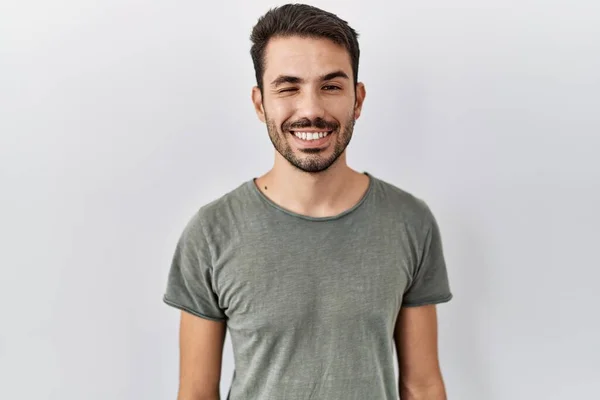 Young Hispanic Man Beard Wearing Casual Shirt White Background Winking — Stok fotoğraf