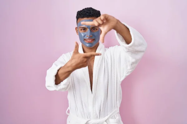 Young Hispanic Man Wearing Beauty Face Mask Bath Robe Smiling — Stok fotoğraf
