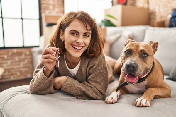 Junge Kaukasierin Mit Schlüssel Für Neues Haus Liegt Mit Hund — Stockfoto