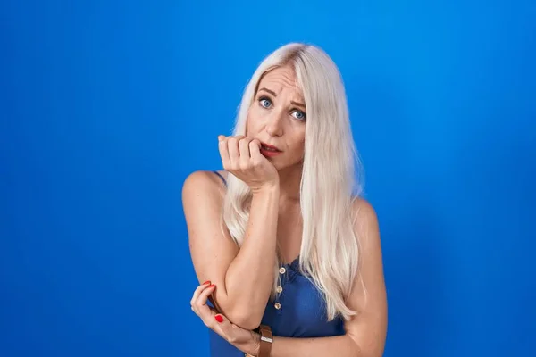 Caucasian Woman Standing Blue Background Looking Stressed Nervous Hands Mouth — Fotografia de Stock