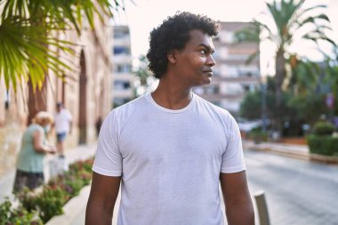 Young south east man smiling confident walking at street