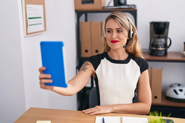 Young beautiful hispanic woman call center agent having video call at office