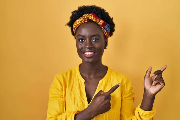 African Young Woman Wearing African Turban Smiling Looking Camera Pointing — Zdjęcie stockowe