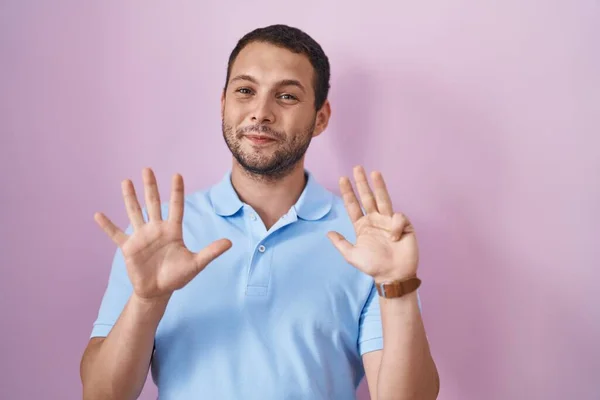 Hispanic Man Standing Pink Background Showing Pointing Fingers Number Nine — Stock Photo, Image