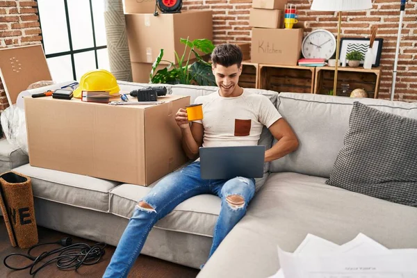 Young Hispanic Man Using Laptop Drinking Coffee Sitting Sofa New — Stock Photo, Image