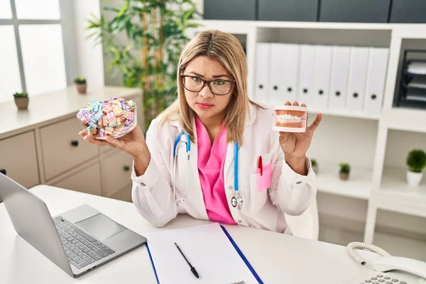 Young Hispanic Dentist Woman Holding Denture Sweets Depressed Worry Distress — Foto de Stock