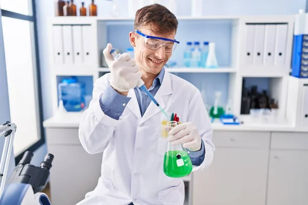 Young Man Scientist Smiling Confident Pouring Liquid Test Tube Laboratory — Photo