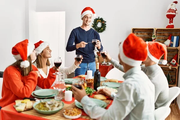 Gruppe Unge Som Smiler Feirer Jul Med Vin Hjemme – stockfoto