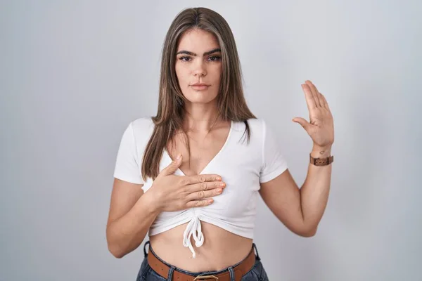 Young Beautiful Woman Wearing Casual White Shirt Swearing Hand Chest — Photo