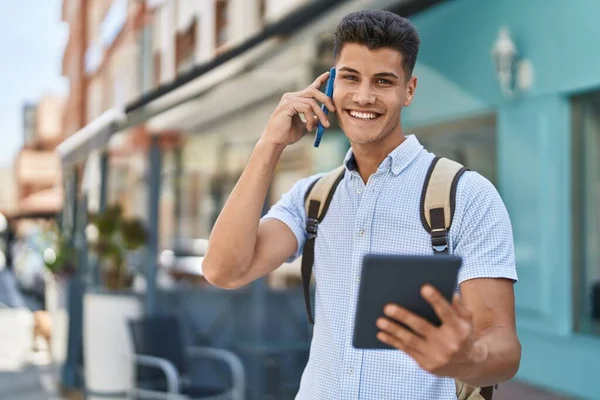 Young Hispanic Man Student Talking Smartphone Using Touchpad Street — Stockfoto