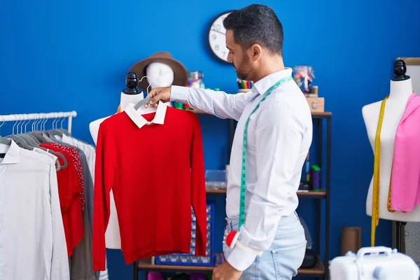 Young Hispanic Man Tailor Holding Clothes Rack Sewing Studio — Stock Photo, Image