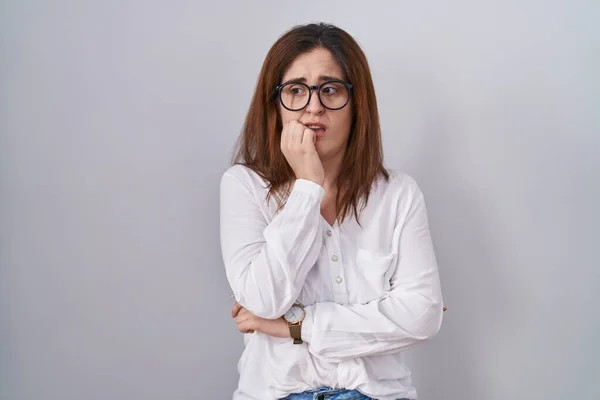 Brunette Woman Standing White Isolated Background Looking Stressed Nervous Hands — Φωτογραφία Αρχείου